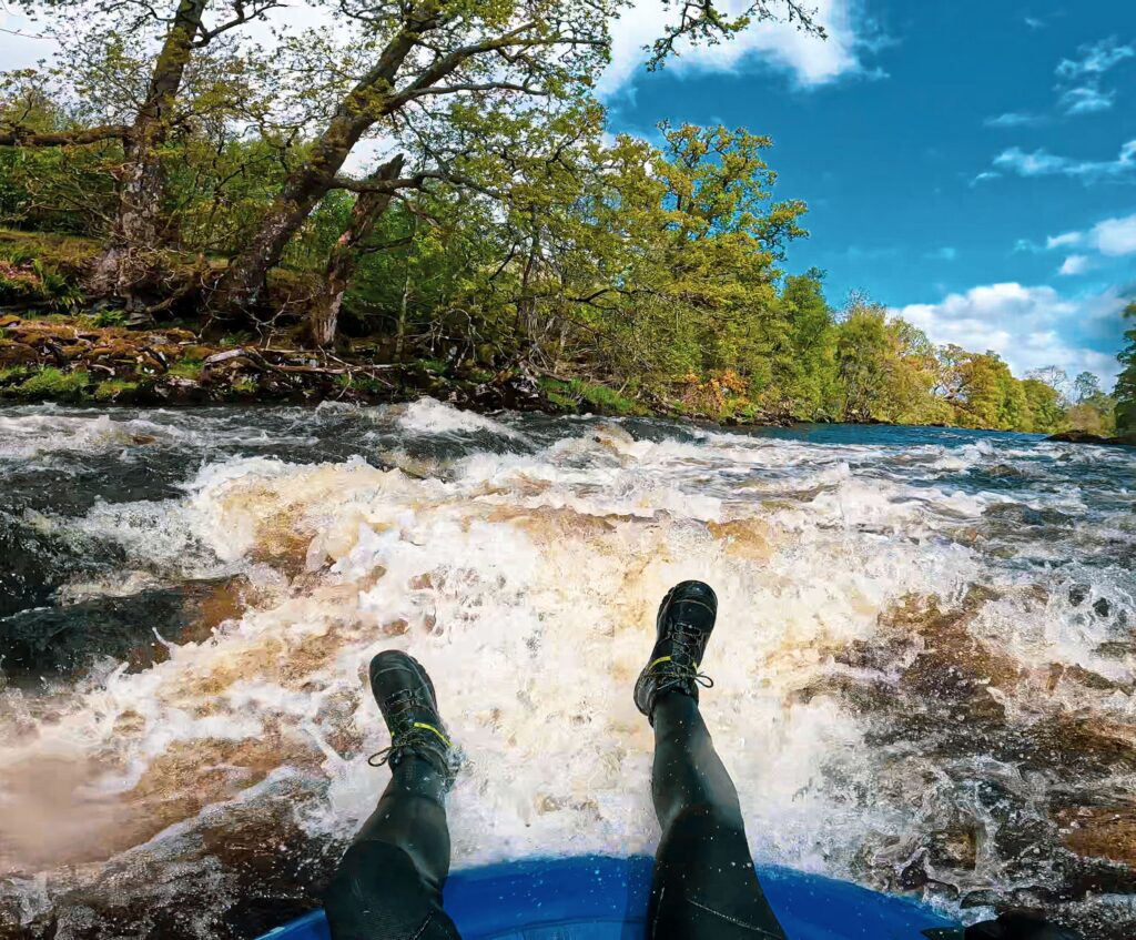 Experience the thrill of river tubing through rapids in the scenic landscapes of Scotland.
