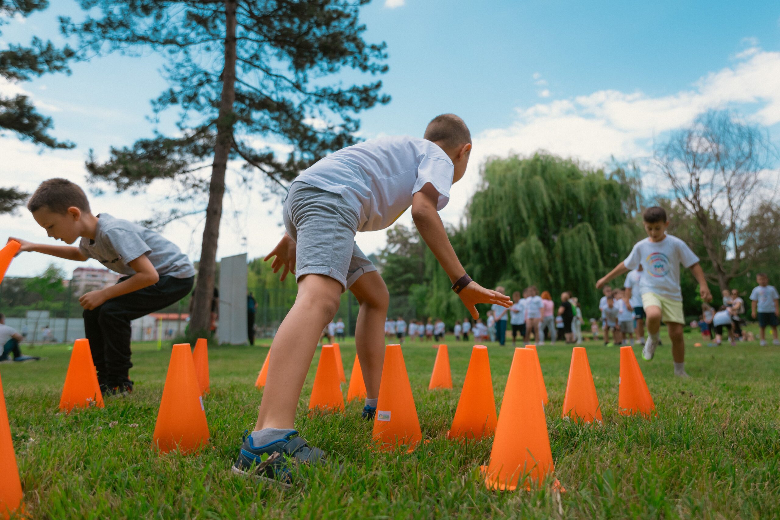 Group of kids enjoying exercise and play at a park obstacle course.